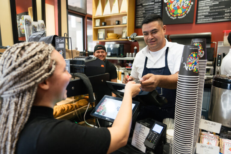 Person at cash register at Coupa Cafe