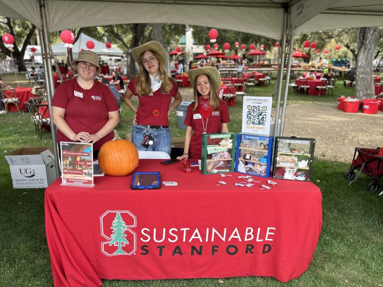 Staff and interns tabling at All Alumni Day with Sustainable Stanford branded table