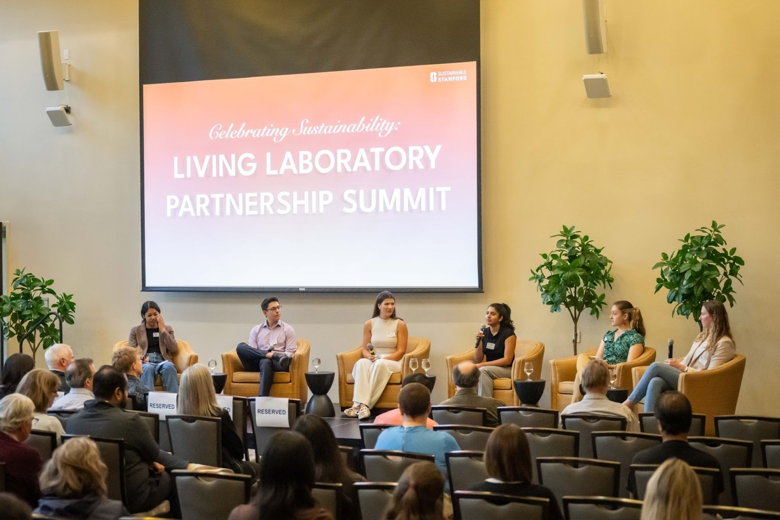 Panel of speakers on stage at Living Lab Partnership Summit