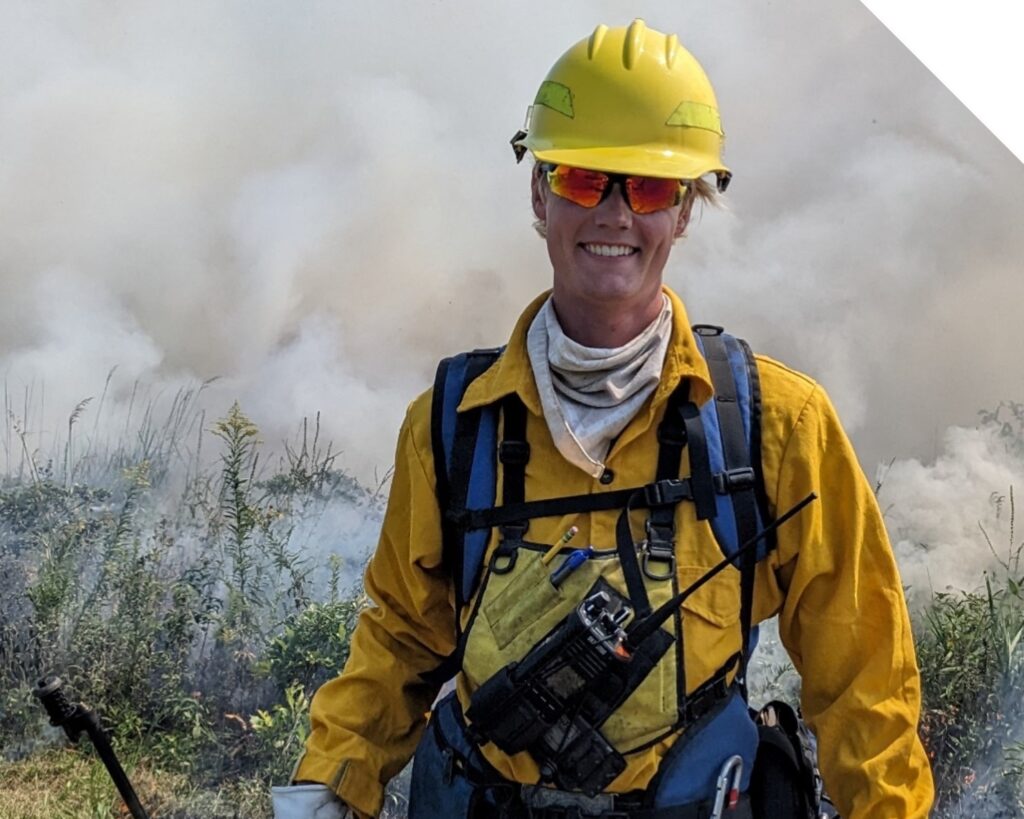 Researcher in fire gear standing in a field of smoke