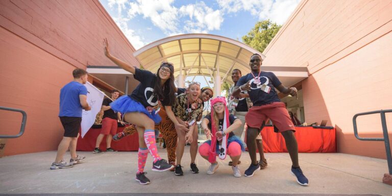 Group of students dressed up in energetic poses