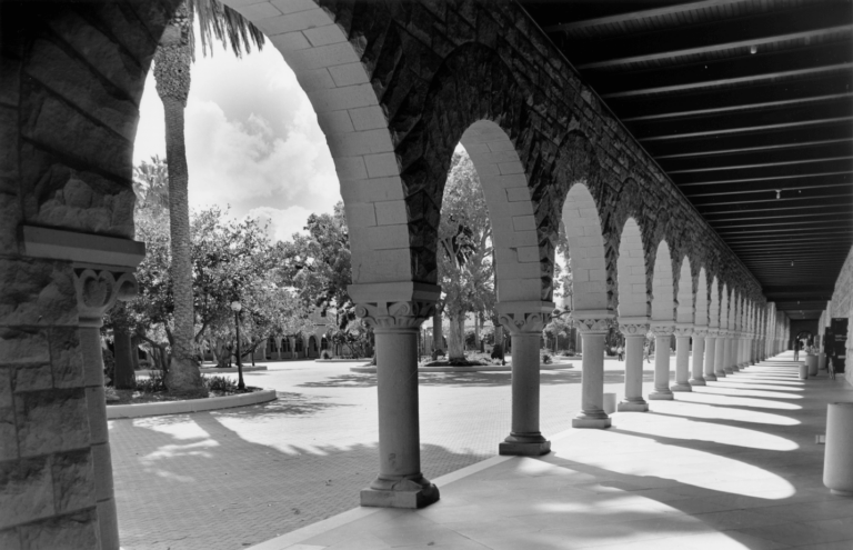 Black and white photo of pillars and arches on Stanford campus