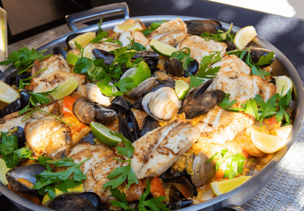 Beautiful seafood dish in pan with clams, mussels, and fish