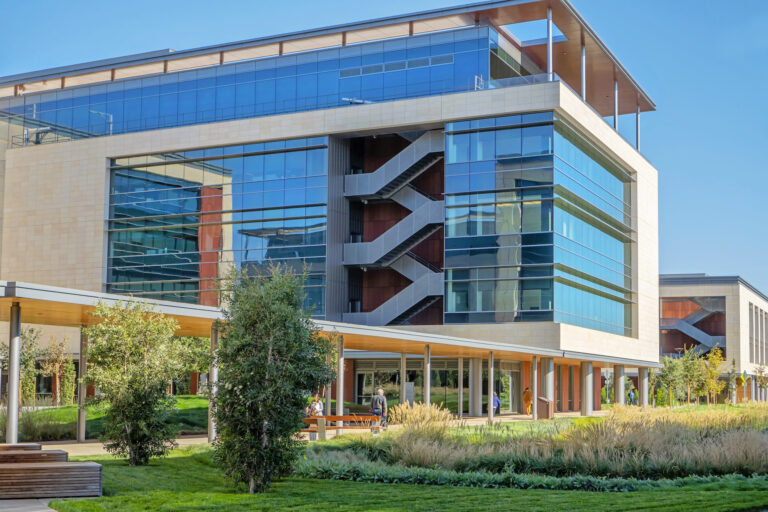Building on Stanford campus with bright blue sky behind