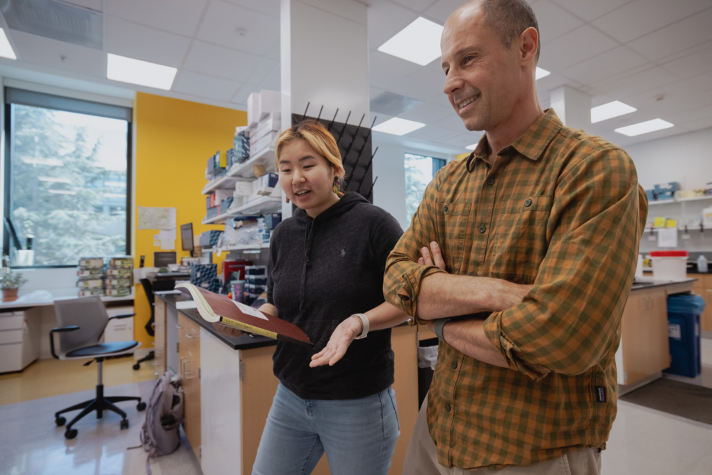 2 Lab Personnel walking through a lab and talking