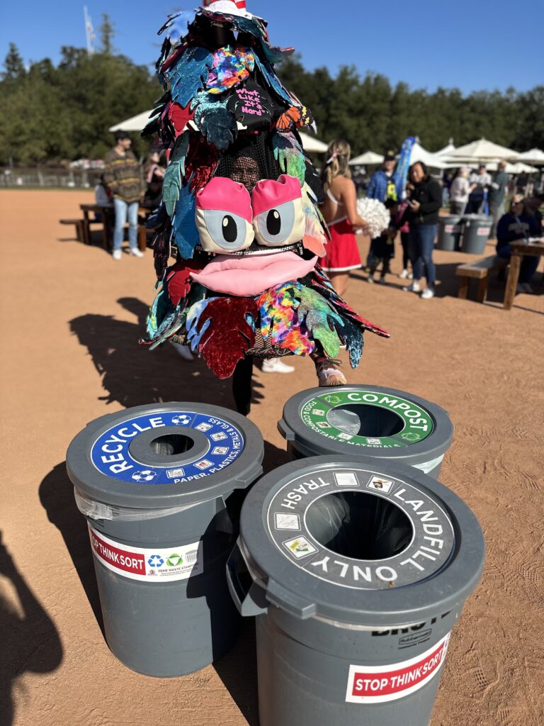 Stanford tree mascot in front of three waste bins