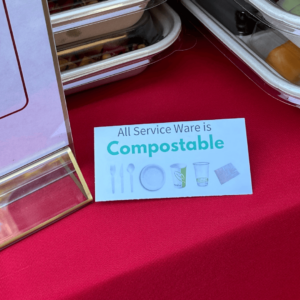 Sign on table that says "all service ware is compostable"