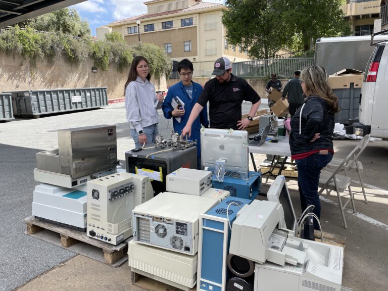People standing with dozens of pieces of equipment