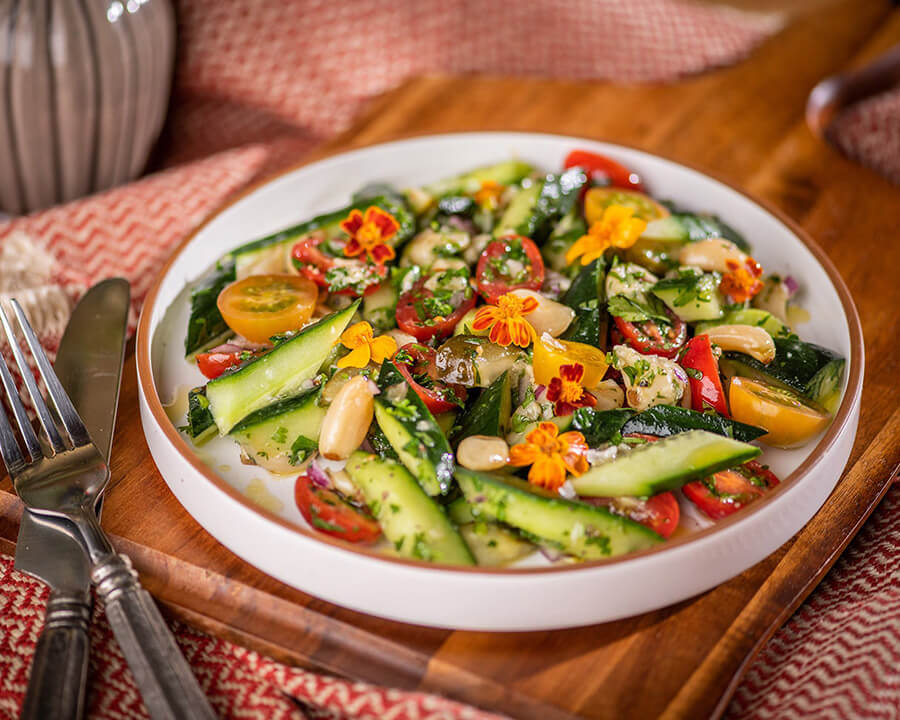 Herbed Persian cucumber salad with heirloom tomatoes and roasted garlic as part of the plant-based menu in Stanford Dinning.