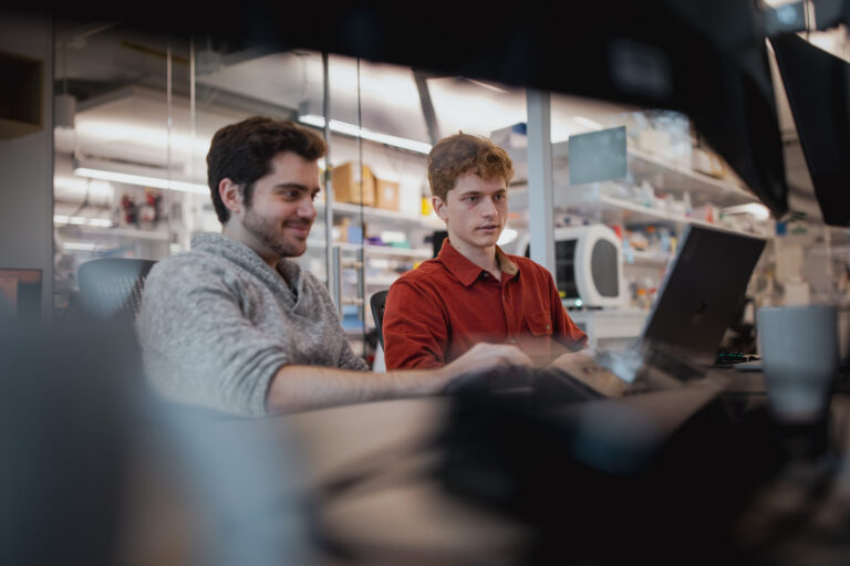 Two people on a laptop in a lab