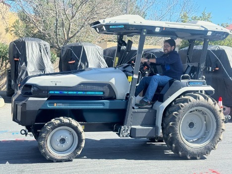 Student fellow Sergio driving a large electric tractor