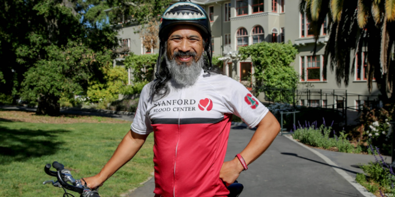 Avid biker, Donnovan Somera Yisrael (‘89), in front of Kingscote Gardens where he works as a Well-Being Coach.