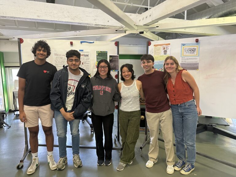 Six students in front of whiteboards at the d.school