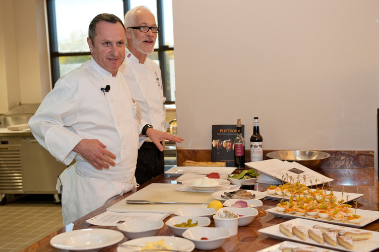 Executive chef Andrew Mayne and guest chef Gerald Hirigoyen with reusable dishware and food at an event